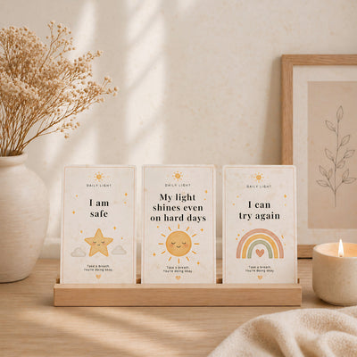 Three motivational prints on a wooden stand with decorative elements.