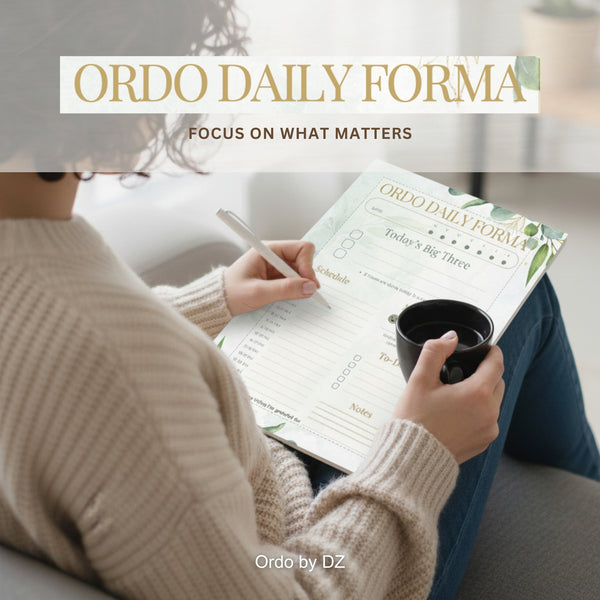 Person holding a cup and using an 'Ordo Daily Forma' planner on a couch. Front page
