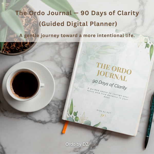 The Ordo Journal on a marble surface with a cup of coffee and pen, featuring text about 90 days of clarity. front cover