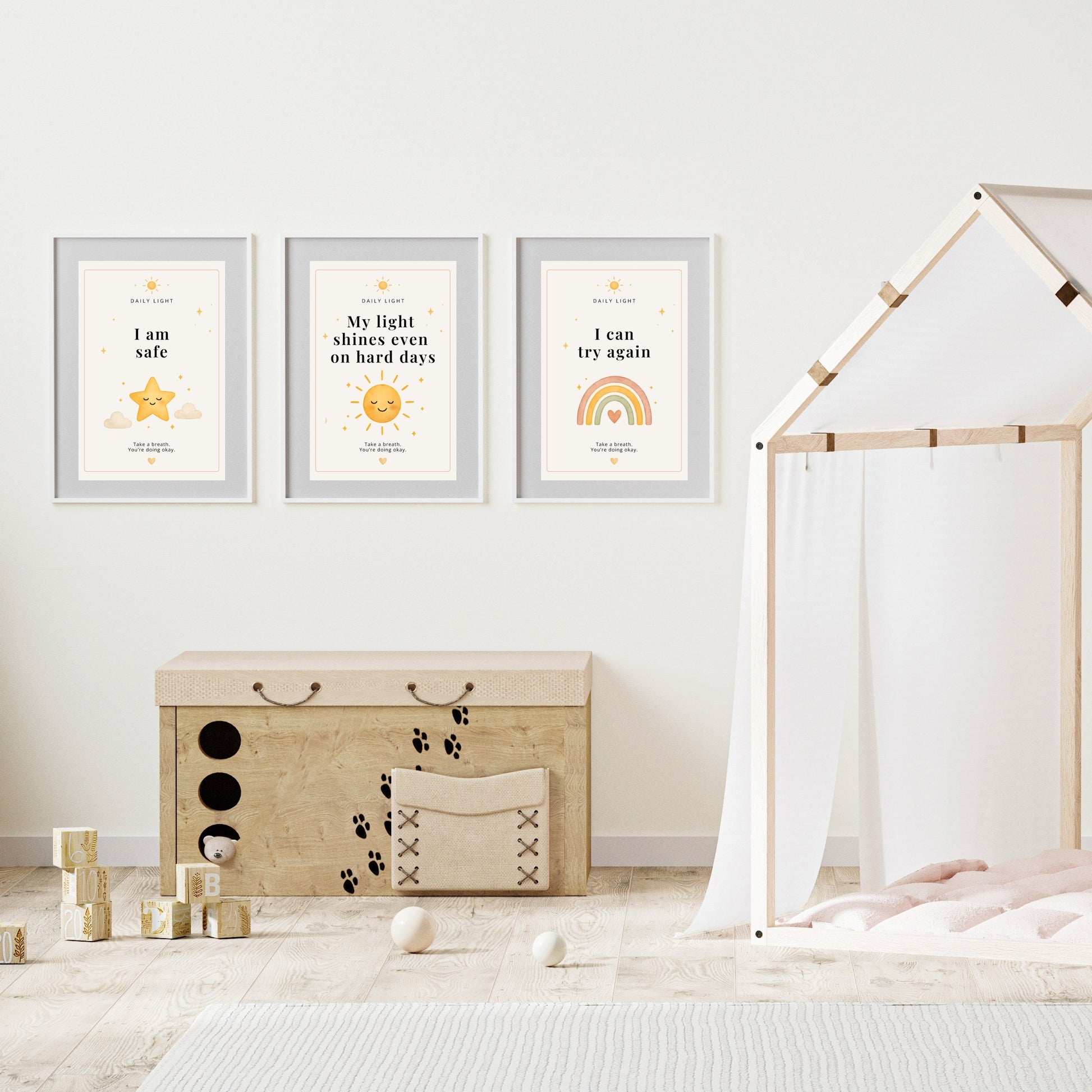 Children's room with framed motivational posters on the wall, a wooden storage box, and toys.