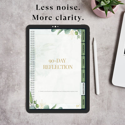 90-Day Reflection planner on a tablet with text 'Less noise. More clarity.' on a gray surface.